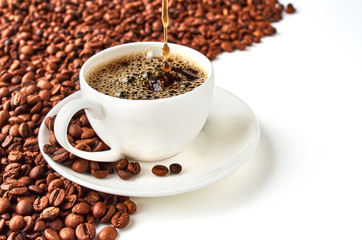 Background of coffee beans and coffee Cup with coffee saucer isolated on white background. Space is provided for your text.