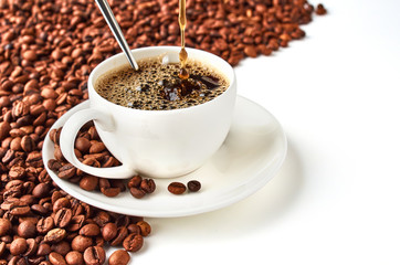 Background of coffee beans and coffee Cup with coffee saucer isolated on white background. Space is provided for your text.