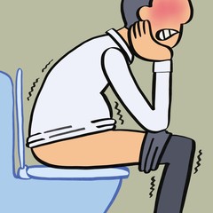 Close up of young man sitting on toilet