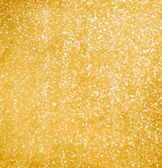 Abstract golden sparkles background. Luxury blured golden texture. The golden surface shines on the light of a thousand lights