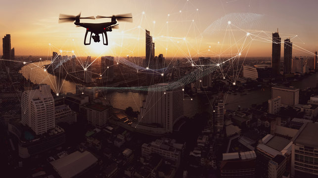 Drone quad copter with high resolution digital camera on the sky mountain and city background.