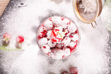 Fototapeta na wymiar delicious dessert of fresh raspberries and strawberries with oatmeal in a glass glass. Verin.
