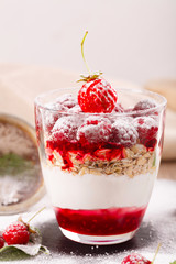delicious dessert of fresh raspberries and strawberries with oatmeal in a glass glass. Verin.