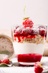 delicious dessert of fresh raspberries and strawberries with oatmeal in a glass glass. Verin.