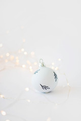 Christmas decoration white christmas ball on white background, lots of copy space for your product or text. bokeh in the background Selective focus.