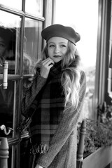  stunning black and white portrait young girl in a beret at a cafe on the street.  Autumn
