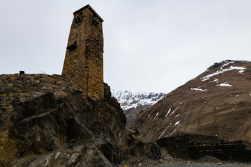 Caucasian tower with snowy mountains background