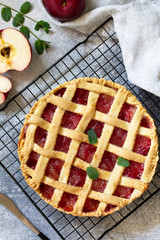 Homemade baking. Autumn apple pie on a light stone or slate table. Top view flat lay.