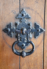 Old metal door handle of a wooden door