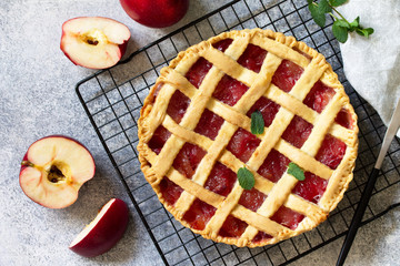 Homemade baking. Autumn apple pie on a light stone or slate table. Top view flat lay.