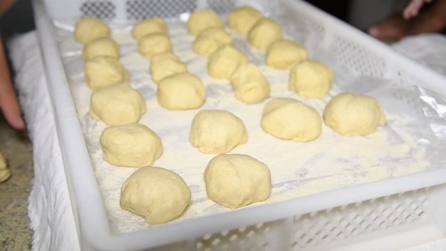 children's hands put dough balls on a stand to make Italian panzerotti pies. Cooking Panzerotti in Puglia, Salento, Italy