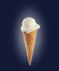 Vanilla ice cream scoop with cone on blue background
