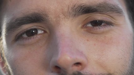 Cropped shot of a happy man smiling to the camera. Unrecognizable man looking to the camera, smiling joyfully. Cheerful male eyes. Happiness, men, diversity concept