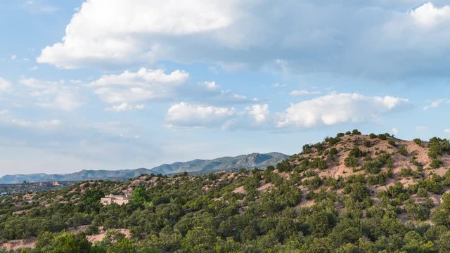 Timelapse or time lapse of high desert mountain, house or home during summer sunset and twilight in Santa Fe, New Mexico