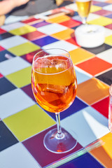 Aperol spritz cocktail on colorful tiled table