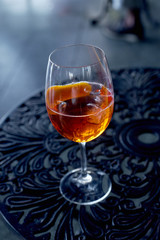 Aperol spritz cocktail on forged metal table