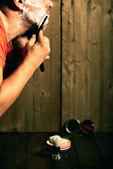 Man shaves with a dangerous razor in the old way.