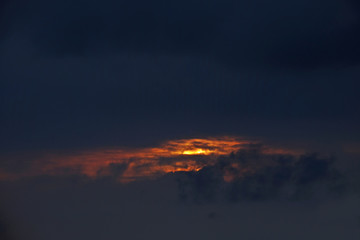 Sunset covered by dark cloud.