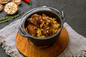 pilaf with beef on black concrete table