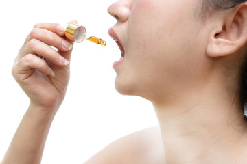 Close up young Asia woman holding a dropper sublingual Cannabis oil Dosing