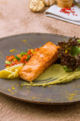 Steak of salmon on grey plate