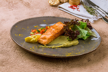 Steak of salmon on grey plate