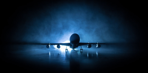 Artwork decoration. White passenger plane ready to taking off from airport runway. Silhouette of Aircraft during night time. © zef art