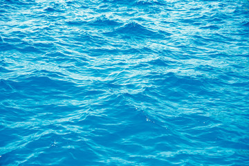 Natural background blue sea with waves, azure clear water beach. Aerial top view