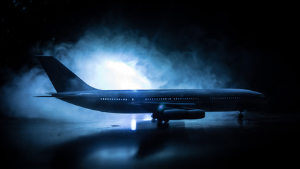 Artwork decoration. White passenger plane ready to taking off from airport runway. Silhouette of...