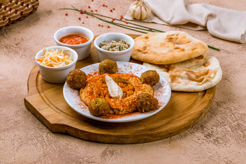 hummus with falafel on the board