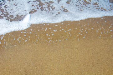 the background of sea foam and yellow sand