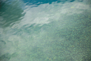 Close up detail of water surface with ripples on it.