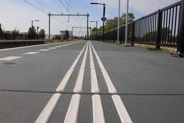 Guiding lines on platform for blind people to feel the save direction on station Lansingerland...