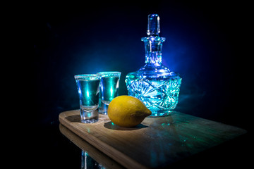 Club drink concept. Tasty alcohol drink cocktail tequila with lime and salt on vibrant dark background or glasses with tequila at a bar