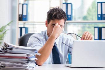 Fototapeta premium Tired exhausted businessman sitting in the office