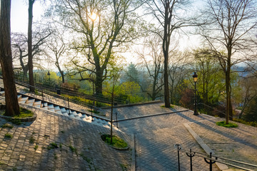 Montmartre in Paris, a very romantic parisian street with typical stairs and lamppost 