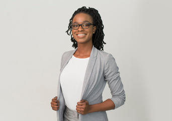 Black Businesswoman Smiling At Camera Standing Over Gray Background
