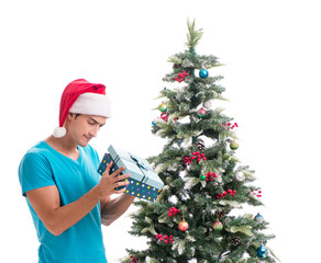 Young man decorating christmas tree isolated on white