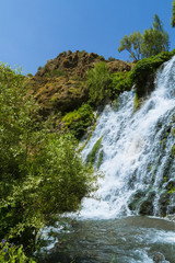 Natural waterfall. Scenery. Summer. Blue sky