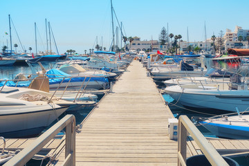 Wooden pier with beautiful ships and boats in the arabic port - Tunisia, Sousse, El Kantaoui 06 19 2019