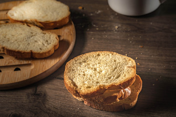 bread for breakfast, with cup of coffee over rustic wooden background with copy space. Morning breakfast with coffee and toasts.