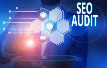 Conceptual hand writing showing Seo Audit. Concept meaning Search Engine Optimization validating and verifying process Male wear formal suit presenting presentation smart device