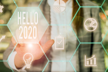 Text sign showing Hello 2020. Business photo text expression or gesture of greeting answering the telephone Female human wear formal work suit presenting presentation use smart device