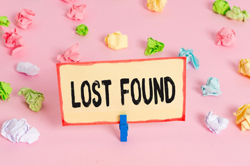 Conceptual hand writing showing Lost Found. Concept meaning Things that are left behind and may retrieve to the owner Colored crumpled papers empty reminder pink floor clothespin