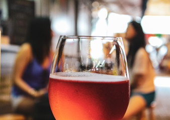 A glass of cold rose wine. Focus on foreground.