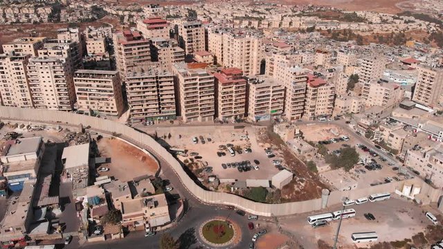 Aerial footage of Palestinian Refugge camp Surrounded By security Concerete Wall Drone Footage of Palestinian Refugge camp Shuafat With Security fence and Army Watch Tower concrete, flight, aerial, ba