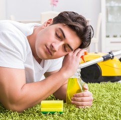 Young husband man cleaning floor at home