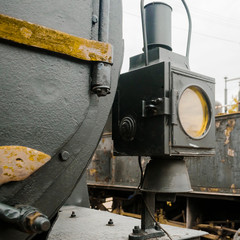 Abstract vintage industry background featuring detail of vintage rusty locomotive tank , with locomotive lights and metal rivets illustrating steam age concept.