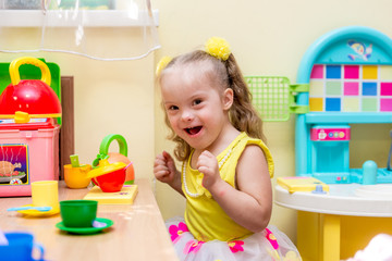 Girl with down syndrom developing motor skills in rehab center for special children © sushytska