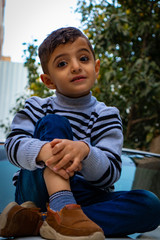 Beautiful child sitting on a car